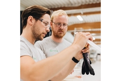 Two men working together in a factory.